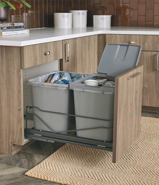 Door-mounted recycling center pull-out for base cabinet