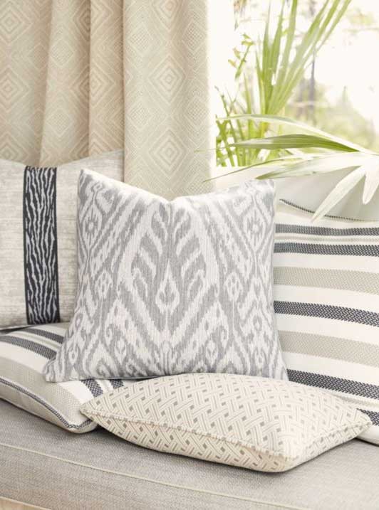 Borneo ikat pillows in indigo and ivory on a layered interior